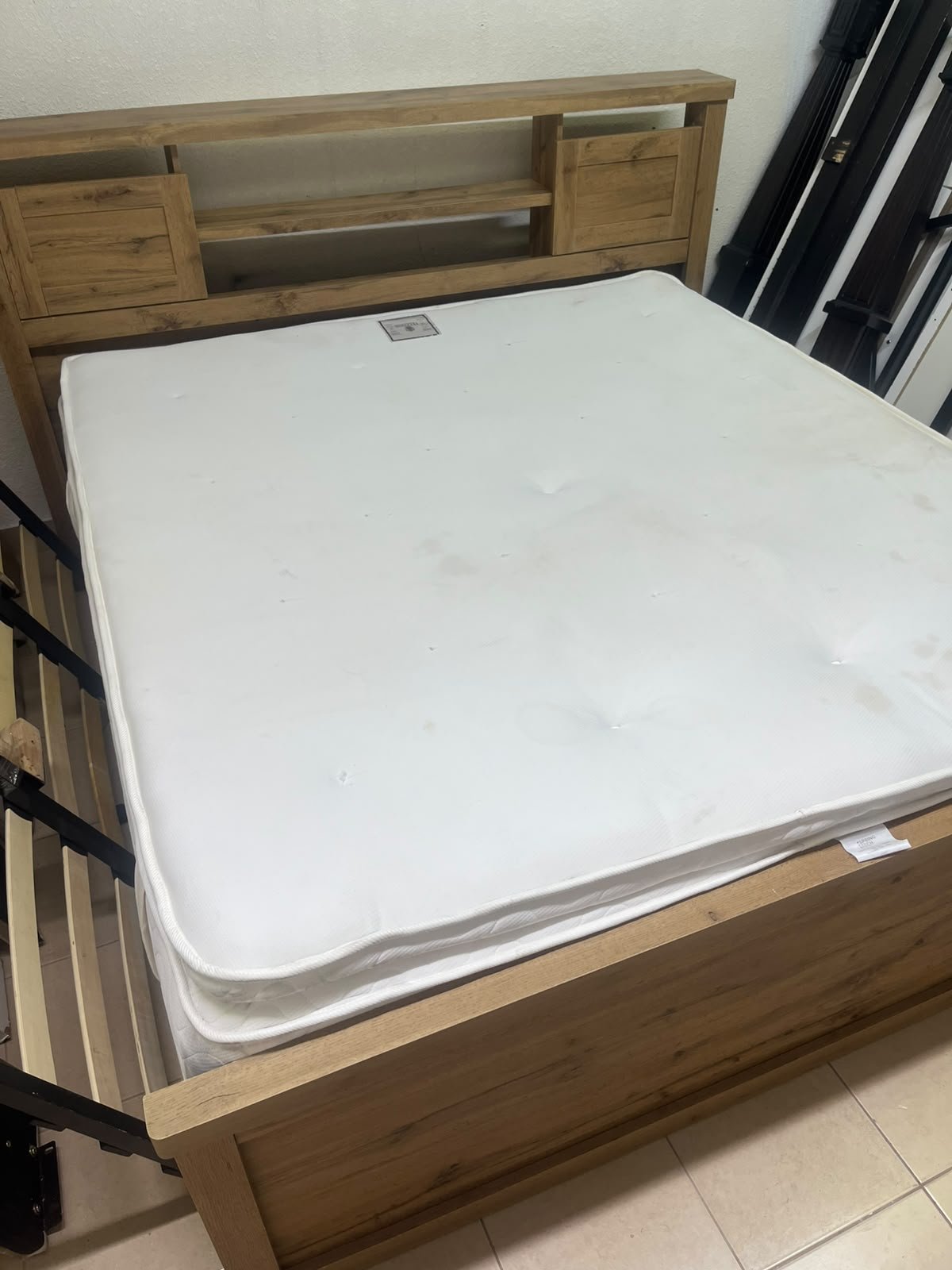 A modern-style wooden double bed (king or queen size) with a mattress, featuring a headboard equipped with shelves and storage cabinets—from Home Centre. - Image 6