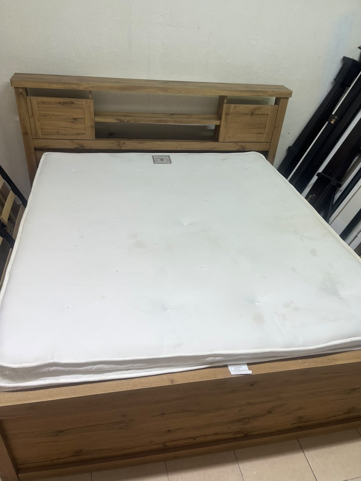 A modern-style wooden double bed (king or queen size) with a mattress, featuring a headboard equipped with shelves and storage cabinets—from Home Centre. - Image 7