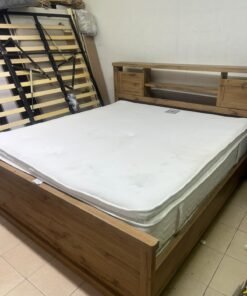 A modern-style wooden double bed (king or queen size) with a mattress, featuring a headboard equipped with shelves and storage cabinets—from Home Centre.