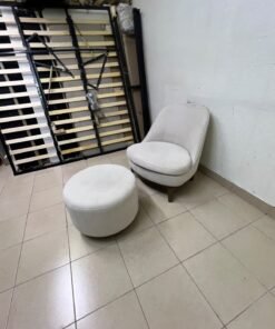 An armchair (poltrona) with a matching footstool (pouffe), featuring a modern, curved design; upholstered in a light beige velvet or linen-like fabric and set upon elegant wooden legs. - Image 6