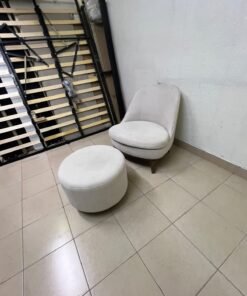 An armchair (poltrona) with a matching footstool (pouffe), featuring a modern, curved design; upholstered in a light beige velvet or linen-like fabric and set upon elegant wooden legs. - Image 8