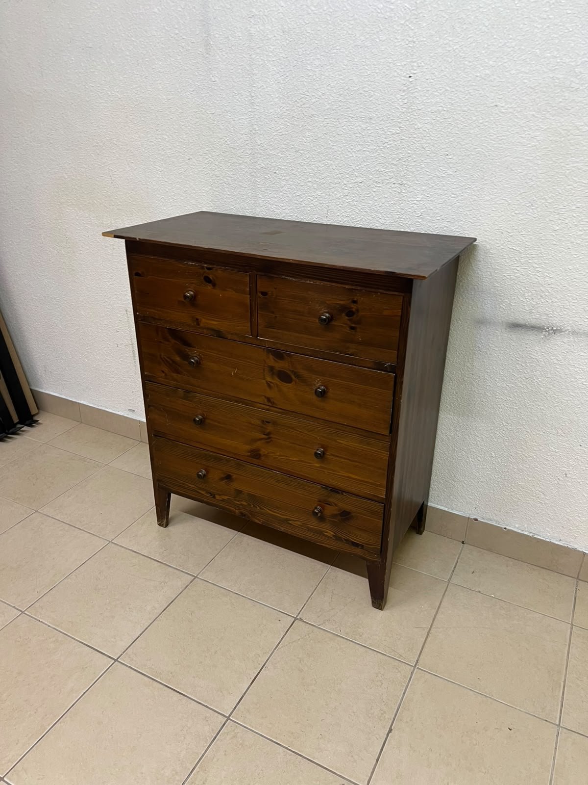 A classic chest of drawers made of solid wood (such as pine or a darker wood), featuring two small drawers at the top and four large, full-width drawers below; it is accented with small, round knobs and elevated wooden legs. - Image 2