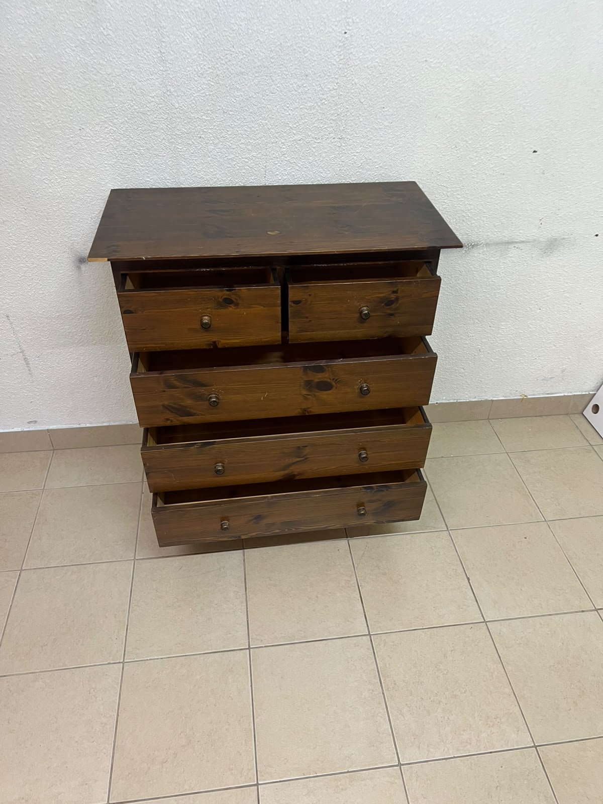A classic chest of drawers made of solid wood (such as pine or a darker wood), featuring two small drawers at the top and four large, full-width drawers below; it is accented with small, round knobs and elevated wooden legs. - Image 5