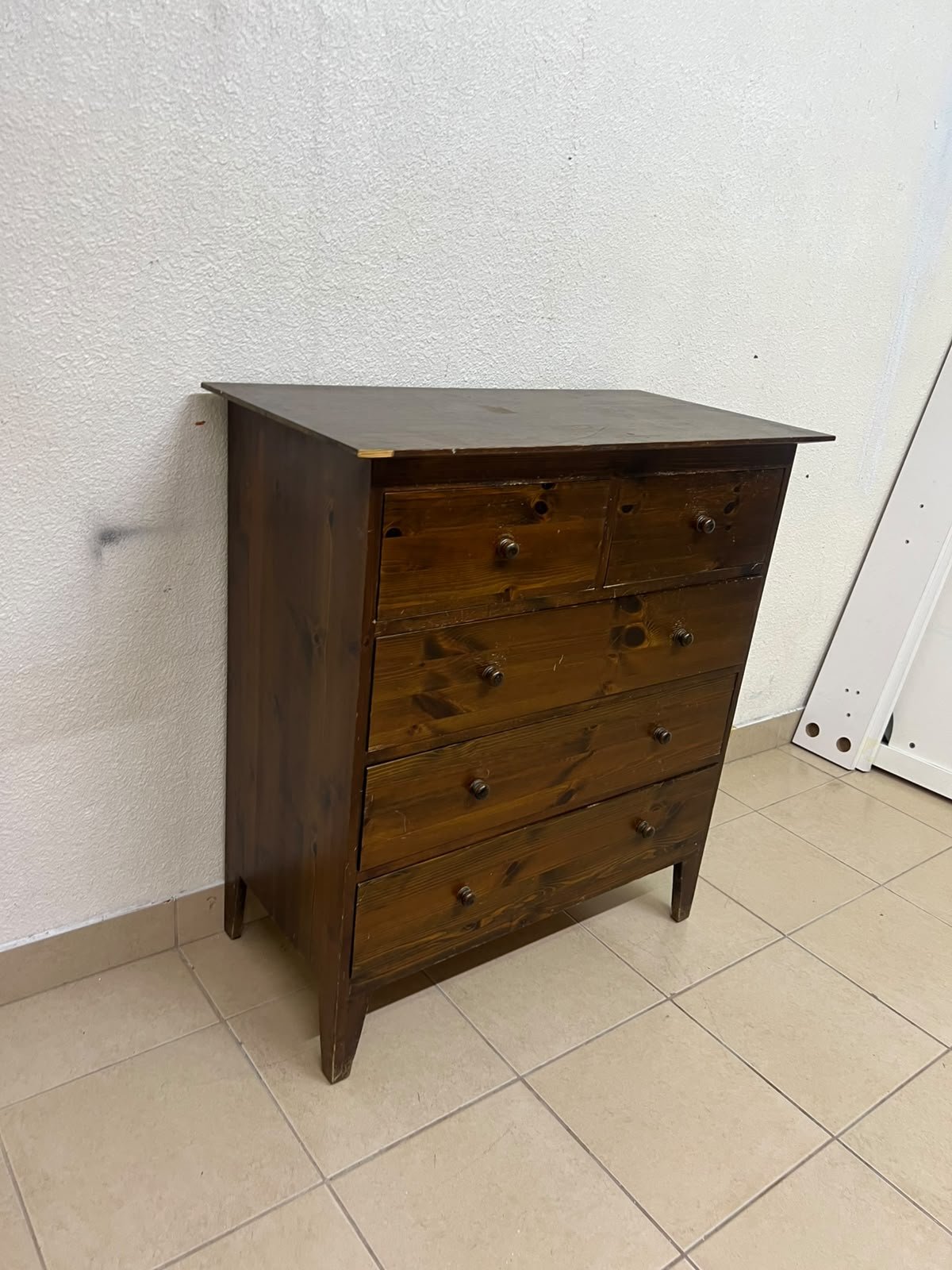 A classic chest of drawers made of solid wood (such as pine or a darker wood), featuring two small drawers at the top and four large, full-width drawers below; it is accented with small, round knobs and elevated wooden legs. - Image 7