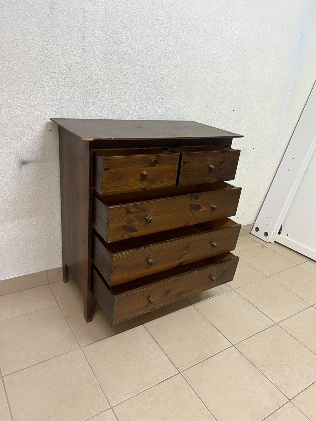 A classic chest of drawers made of solid wood (such as pine or a darker wood), featuring two small drawers at the top and four large, full-width drawers below; it is accented with small, round knobs and elevated wooden legs. - Image 11