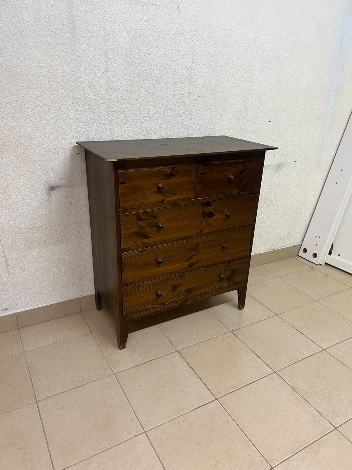 A classic chest of drawers made of solid wood (such as pine or a darker wood), featuring two small drawers at the top and four large, full-width drawers below; it is accented with small, round knobs and elevated wooden legs. - Image 4