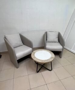 A seating set consisting of two individual grey chairs with square back cushions, with a small, round coffee table—featuring a white top and a black metal base—placed between them. - Image 7