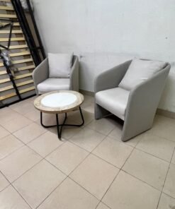 A seating set consisting of two individual grey chairs with square back cushions, with a small, round coffee table—featuring a white top and a black metal base—placed between them. - Image 8