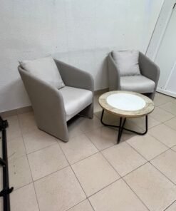 A seating set consisting of two individual grey chairs with square back cushions, with a small, round coffee table—featuring a white top and a black metal base—placed between them. - Image 9