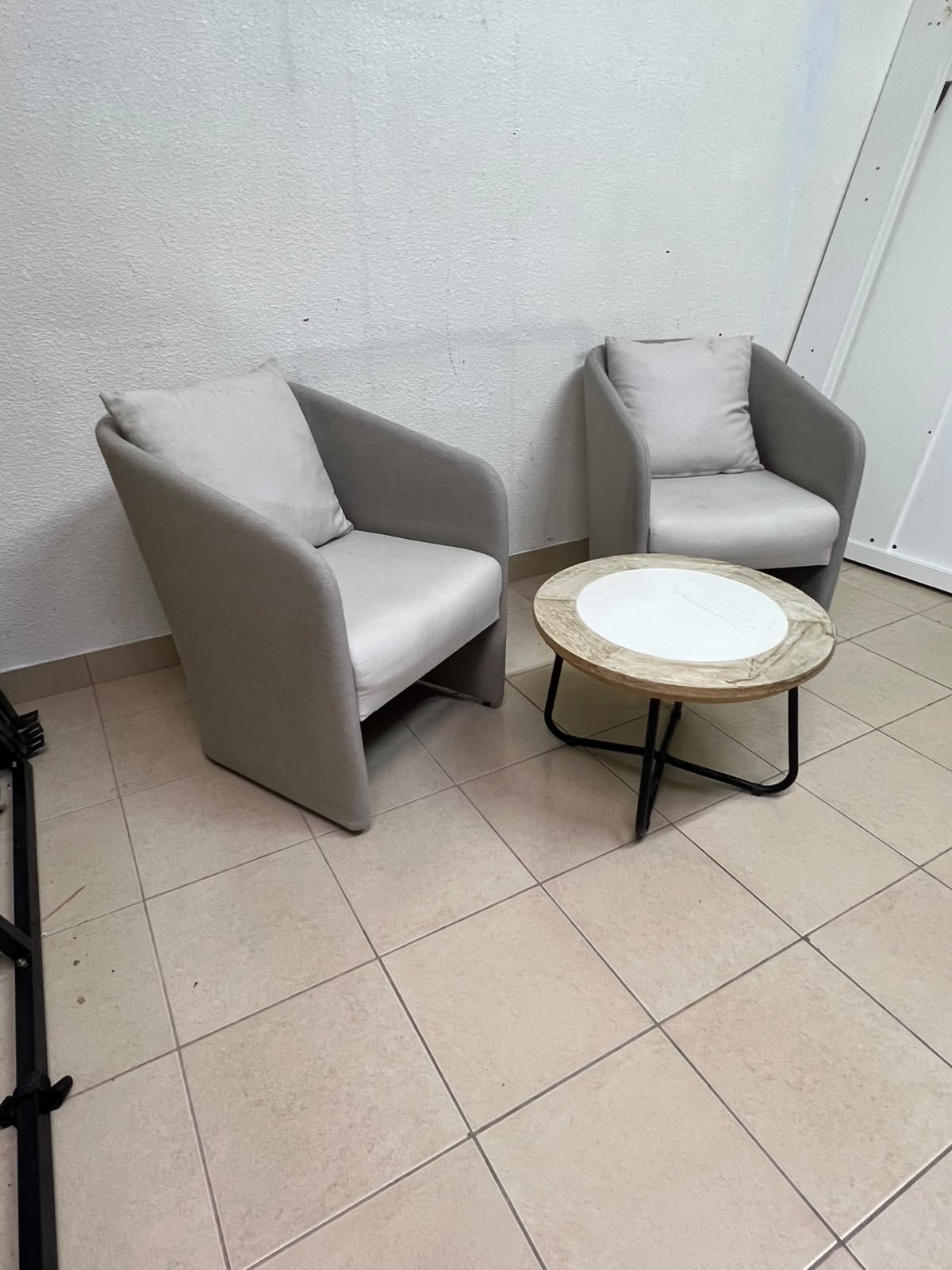 A seating set consisting of two individual grey chairs with square back cushions, with a small, round coffee table—featuring a white top and a black metal base—placed between them. - Image 9