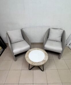 A seating set consisting of two individual grey chairs with square back cushions, with a small, round coffee table—featuring a white top and a black metal base—placed between them. - Image 10