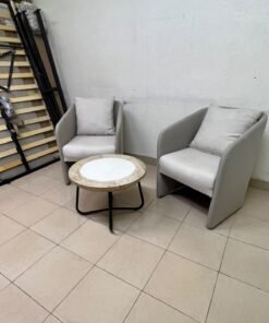 A seating set consisting of two individual grey chairs with square back cushions, with a small, round coffee table—featuring a white top and a black metal base—placed between them. - Image 3