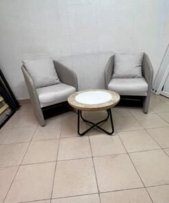 A seating set consisting of two individual grey chairs with square back cushions, with a small, round coffee table—featuring a white top and a black metal base—placed between them. - Image 4