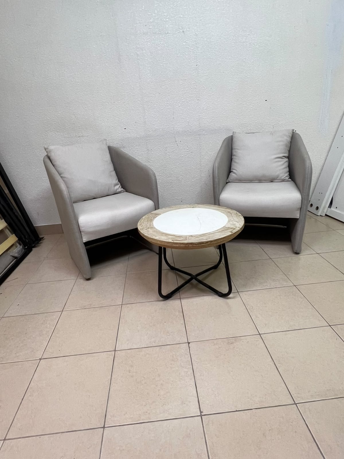 A seating set consisting of two individual grey chairs with square back cushions, with a small, round coffee table—featuring a white top and a black metal base—placed between them. - Image 4