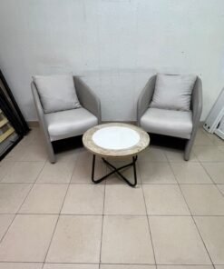 A seating set consisting of two individual grey chairs with square back cushions, with a small, round coffee table—featuring a white top and a black metal base—placed between them. - Image 6