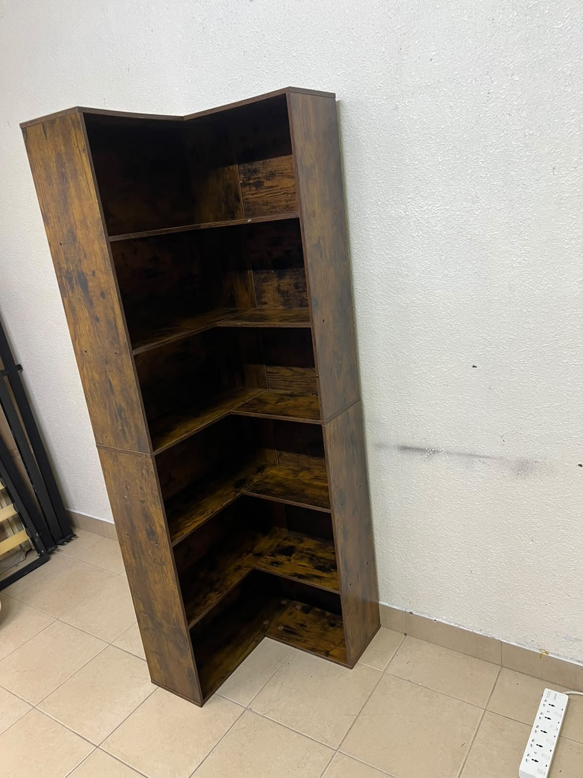 An L-shaped corner bookshelf, crafted from engineered wood in a dark, rustic brown (Vintage/Amber Pine) finish. - Image 2