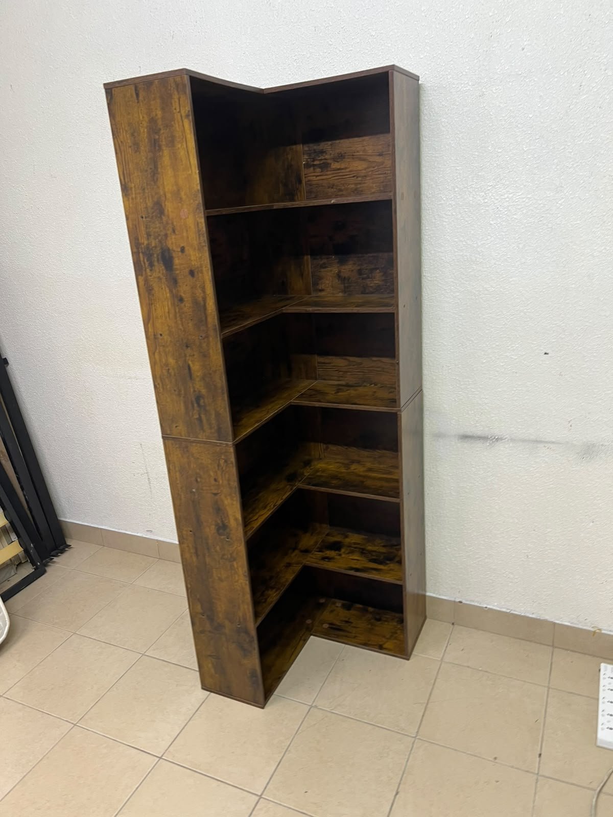 An L-shaped corner bookshelf, crafted from engineered wood in a dark, rustic brown (Vintage/Amber Pine) finish. - Image 5