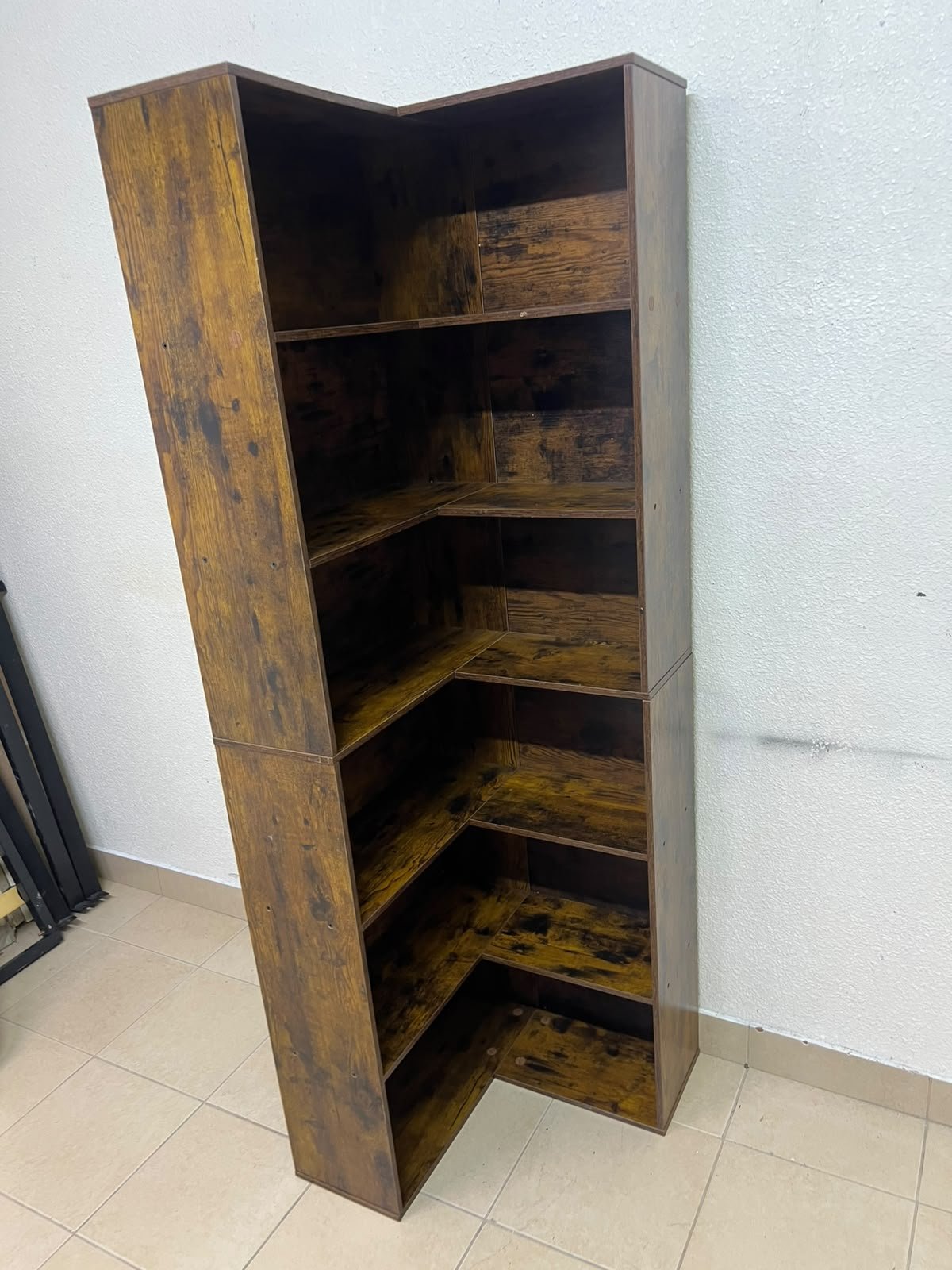 An L-shaped corner bookshelf, crafted from engineered wood in a dark, rustic brown (Vintage/Amber Pine) finish.