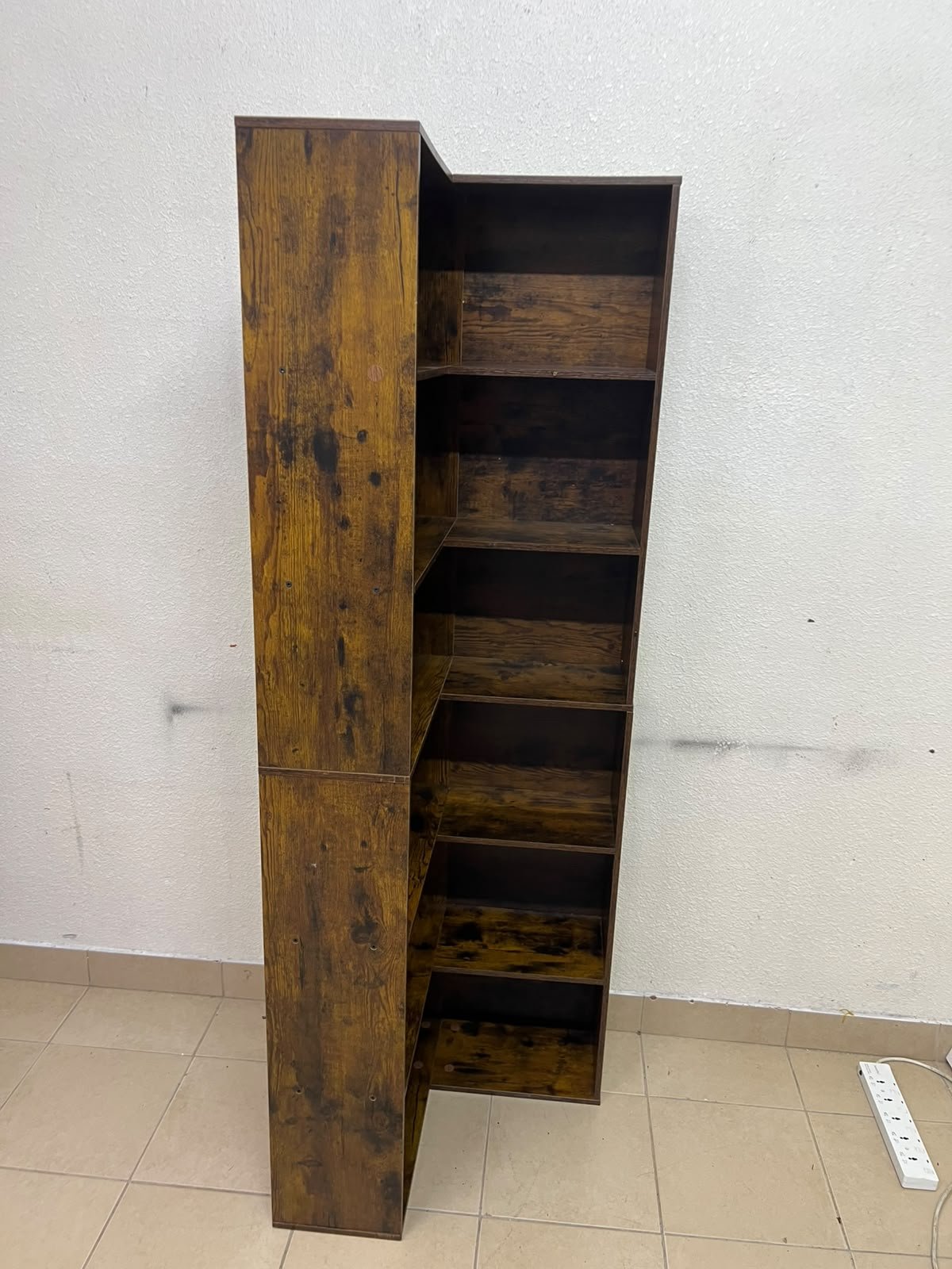 An L-shaped corner bookshelf, crafted from engineered wood in a dark, rustic brown (Vintage/Amber Pine) finish. - Image 9