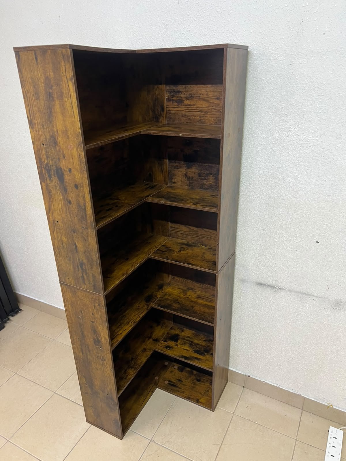 An L-shaped corner bookshelf, crafted from engineered wood in a dark, rustic brown (Vintage/Amber Pine) finish. - Image 10
