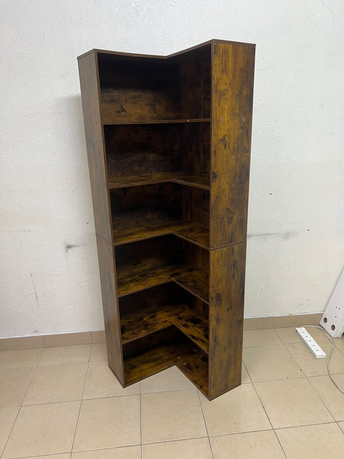 An L-shaped corner bookshelf, crafted from engineered wood in a dark, rustic brown (Vintage/Amber Pine) finish. - Image 4
