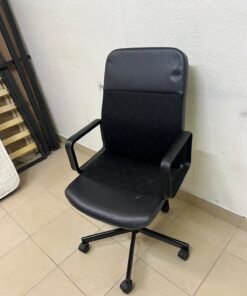 An IKEA swivel office chair known as the RENBERGET swivel chair, in black Bomstad.