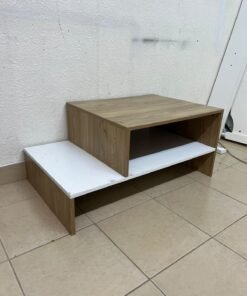 A coffee table with a modern, tiered design (such as the Bruno coffee table by Alford, available at Home Box UAE or Danube Home).