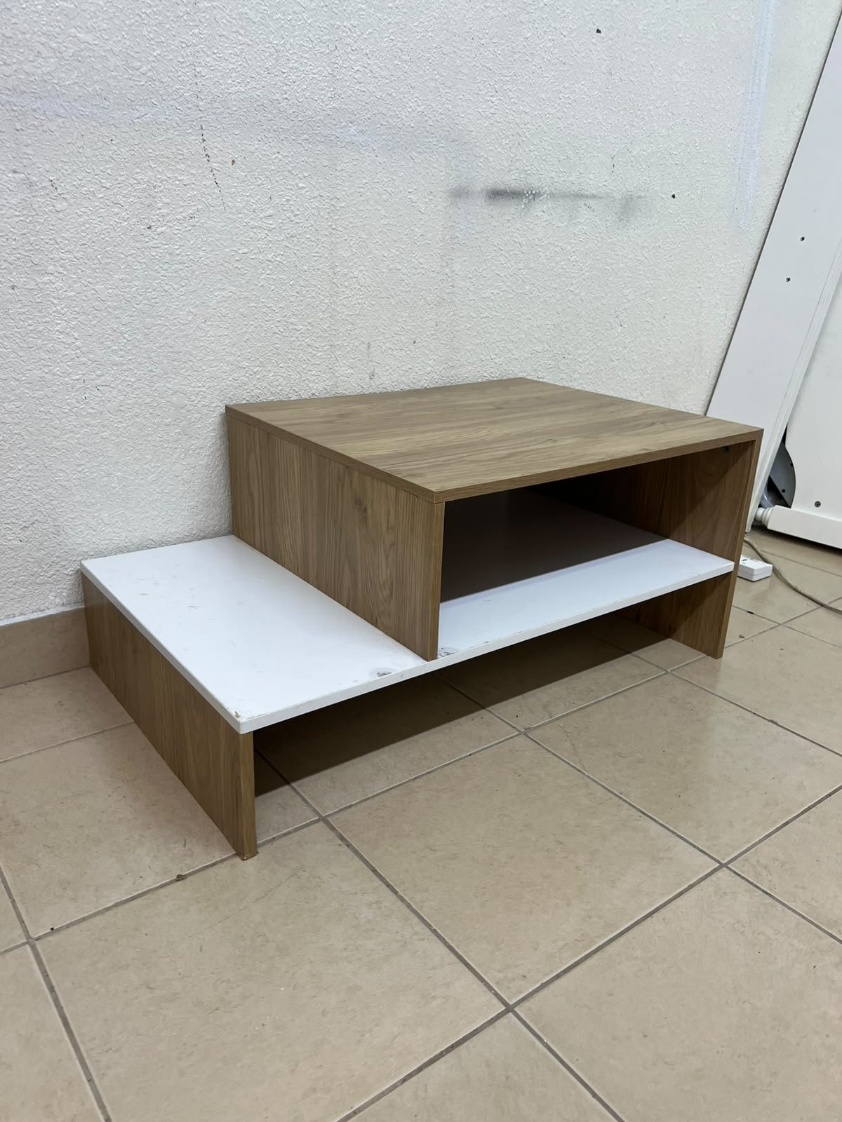 A coffee table with a modern, tiered design (such as the Bruno coffee table by Alford, available at Home Box UAE or Danube Home).