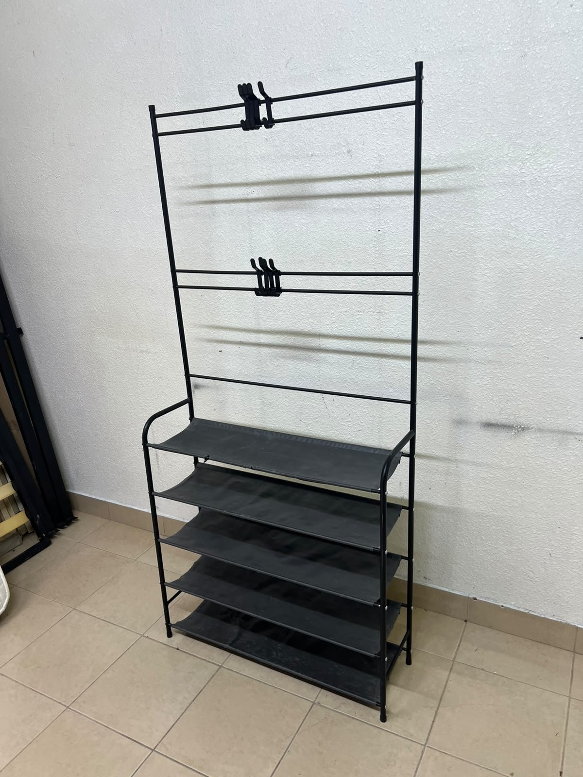 A versatile shoe and clothing organizer (5-tier, featuring top hangers) constructed from metal tubes and fabric storage shelves.