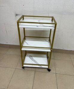 A 3-tier storage or serving cart on wheels, featuring a gold-colored metal frame and white, marble-design shelves. - Image 4