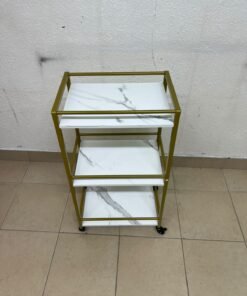 A 3-tier storage or serving cart on wheels, featuring a gold-colored metal frame and white, marble-design shelves. - Image 5