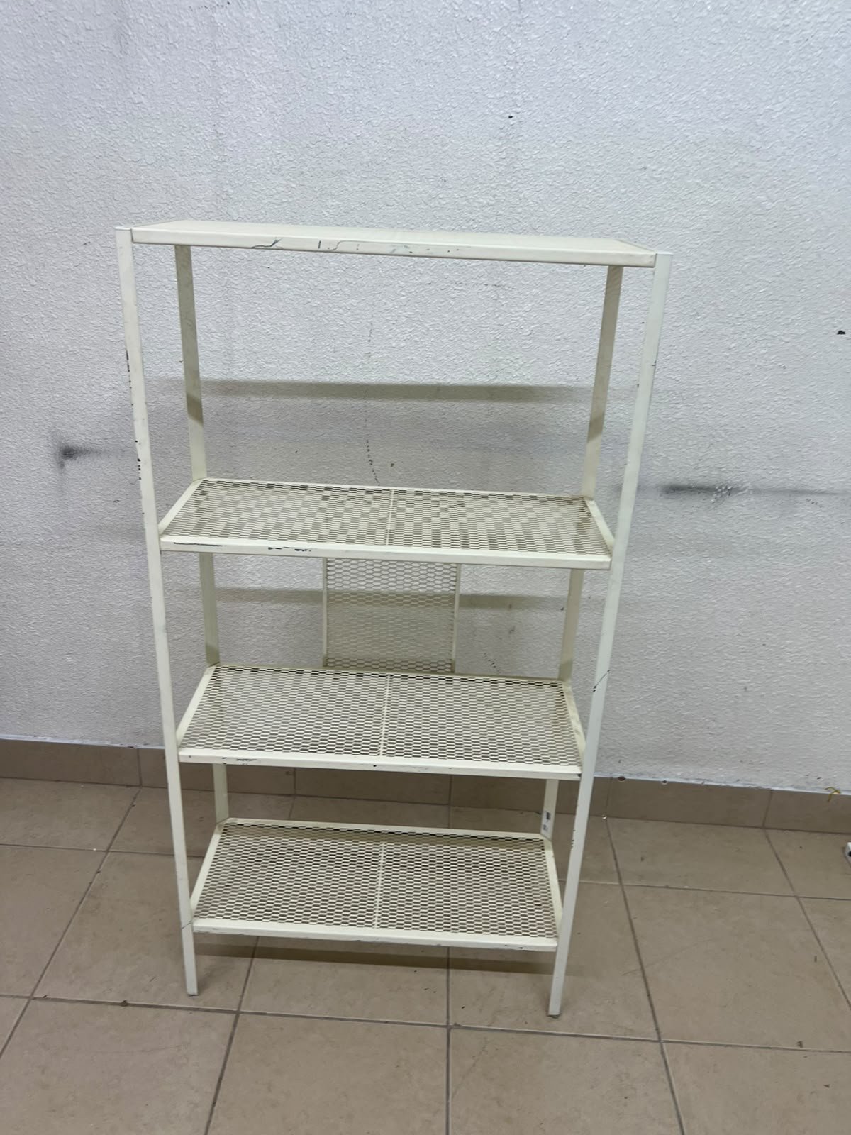 An IKEA shelving unit known as BAGGEBO, made of metal and finished in white.