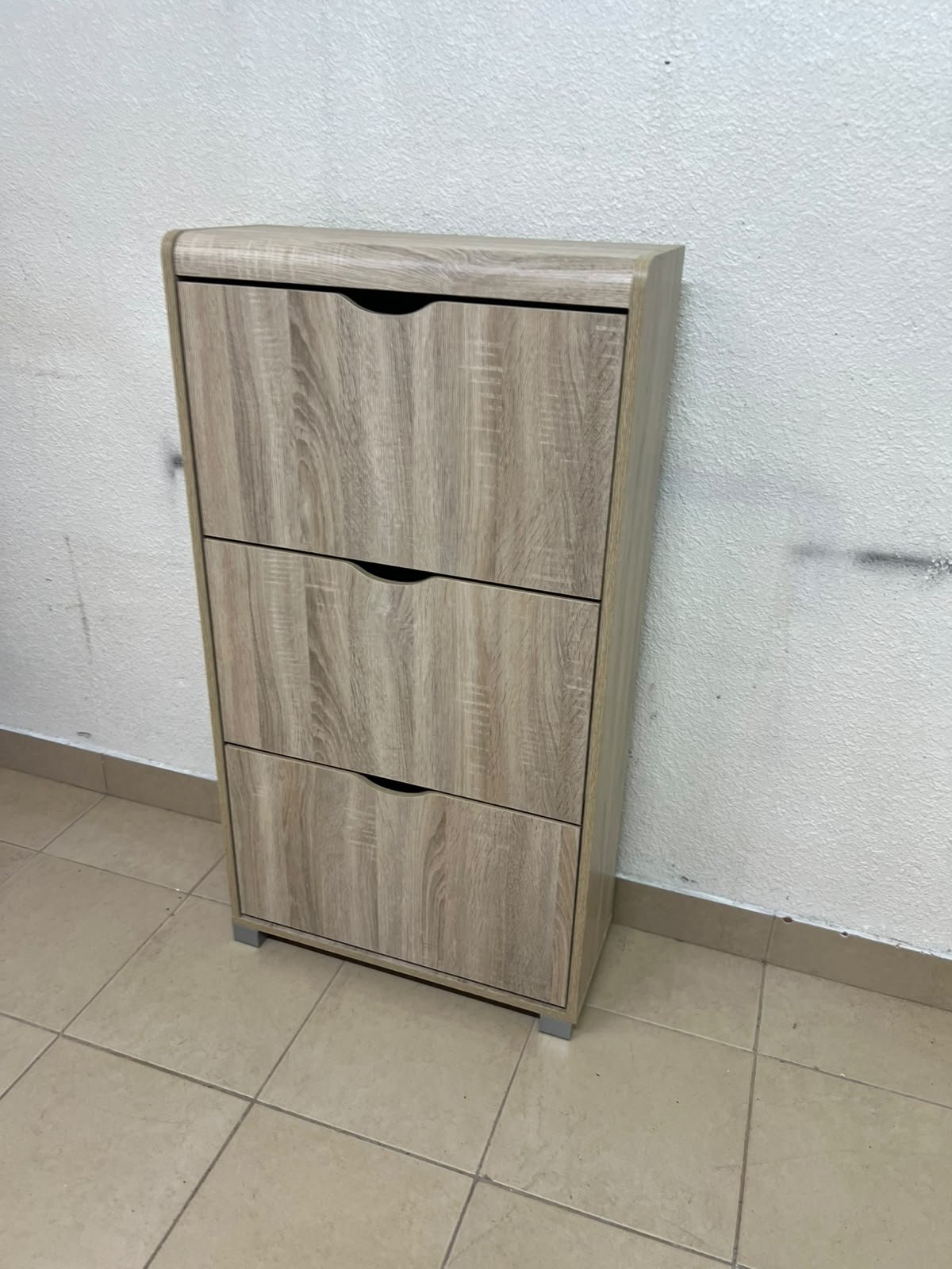 Slim 3-drawer shoe cabinet with a fold-out design, in a natural oak finish.