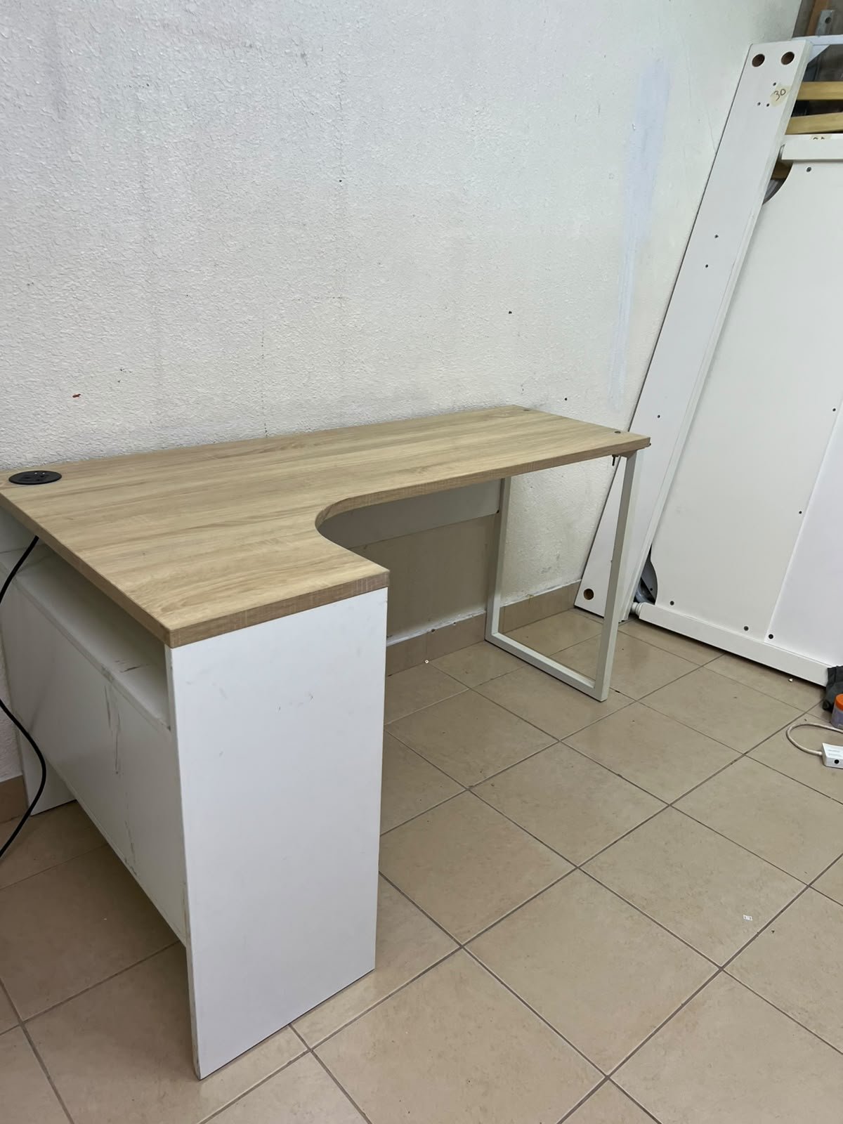 An L-shaped corner desk in white, featuring a light wood-tone (oak) surface and two drawers, complete with side storage units that include two drawers and open shelving. - Image 3