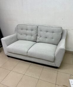 A light gray/beige two-seater fabric sofa featuring button-tufted backrests and short black legs; it closely resembles models such as the Pan Emirates Rosebond two-seater or the Pan Emirates Akli two-seater. - Image 2