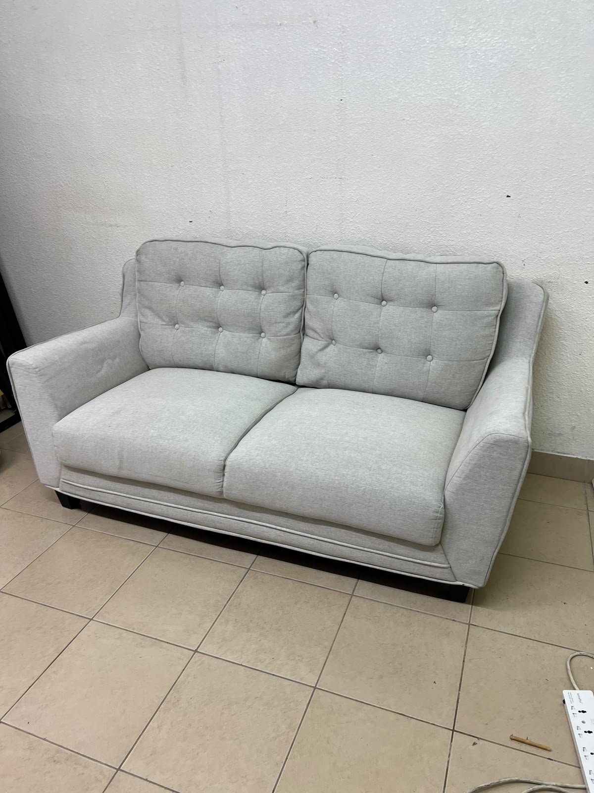 A light gray/beige two-seater fabric sofa featuring button-tufted backrests and short black legs; it closely resembles models such as the Pan Emirates Rosebond two-seater or the Pan Emirates Akli two-seater. - Image 2