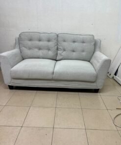 A light gray/beige two-seater fabric sofa featuring button-tufted backrests and short black legs; it closely resembles models such as the Pan Emirates Rosebond two-seater or the Pan Emirates Akli two-seater. - Image 4