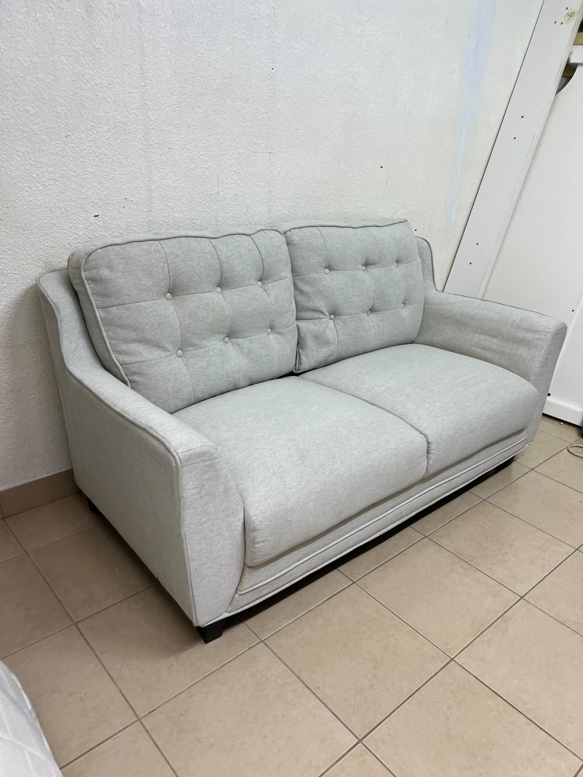 A light gray/beige two-seater fabric sofa featuring button-tufted backrests and short black legs; it closely resembles models such as the Pan Emirates Rosebond two-seater or the Pan Emirates Akli two-seater. - Image 7
