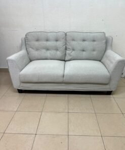 A light gray/beige two-seater fabric sofa featuring button-tufted backrests and short black legs; it closely resembles models such as the Pan Emirates Rosebond two-seater or the Pan Emirates Akli two-seater. - Image 8