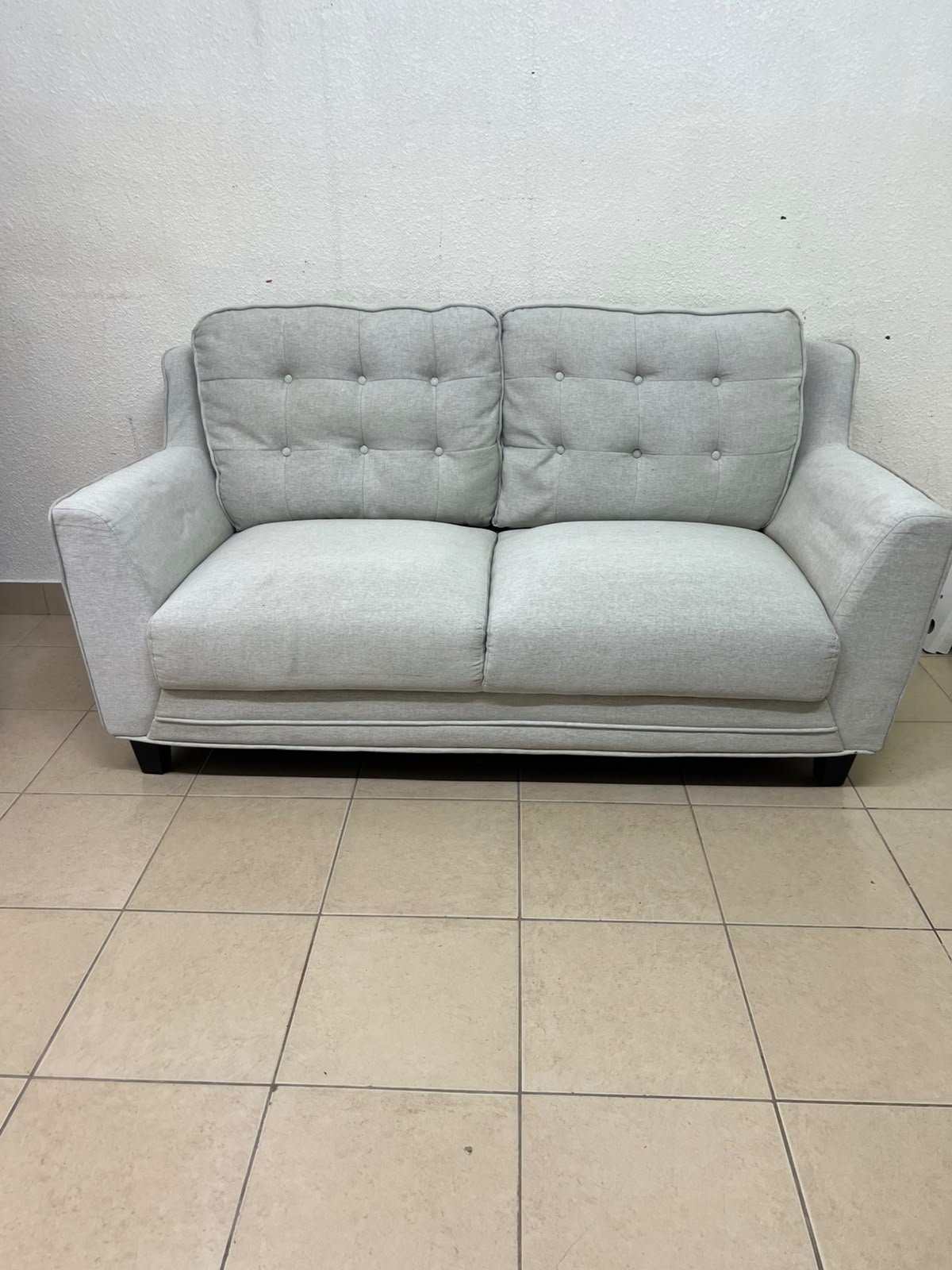 A light gray/beige two-seater fabric sofa featuring button-tufted backrests and short black legs; it closely resembles models such as the Pan Emirates Rosebond two-seater or the Pan Emirates Akli two-seater. - Image 8