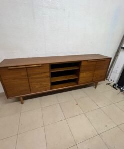 A walnut-wood TV unit or media cabinet from Home Centre, featuring open central shelving, enclosed side cabinets, and slender, tapered legs. - Image 2