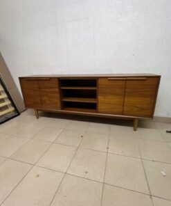 A walnut-wood TV unit or media cabinet from Home Centre, featuring open central shelving, enclosed side cabinets, and slender, tapered legs. - Image 5