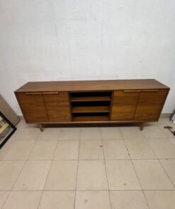 A walnut-wood TV unit or media cabinet from Home Centre, featuring open central shelving, enclosed side cabinets, and slender, tapered legs. - Image 6