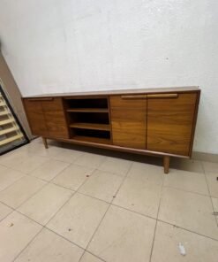 A walnut-wood TV unit or media cabinet from Home Centre, featuring open central shelving, enclosed side cabinets, and slender, tapered legs. - Image 8