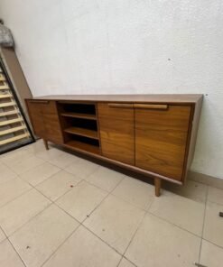 A walnut-wood TV unit or media cabinet from Home Centre, featuring open central shelving, enclosed side cabinets, and slender, tapered legs. - Image 9