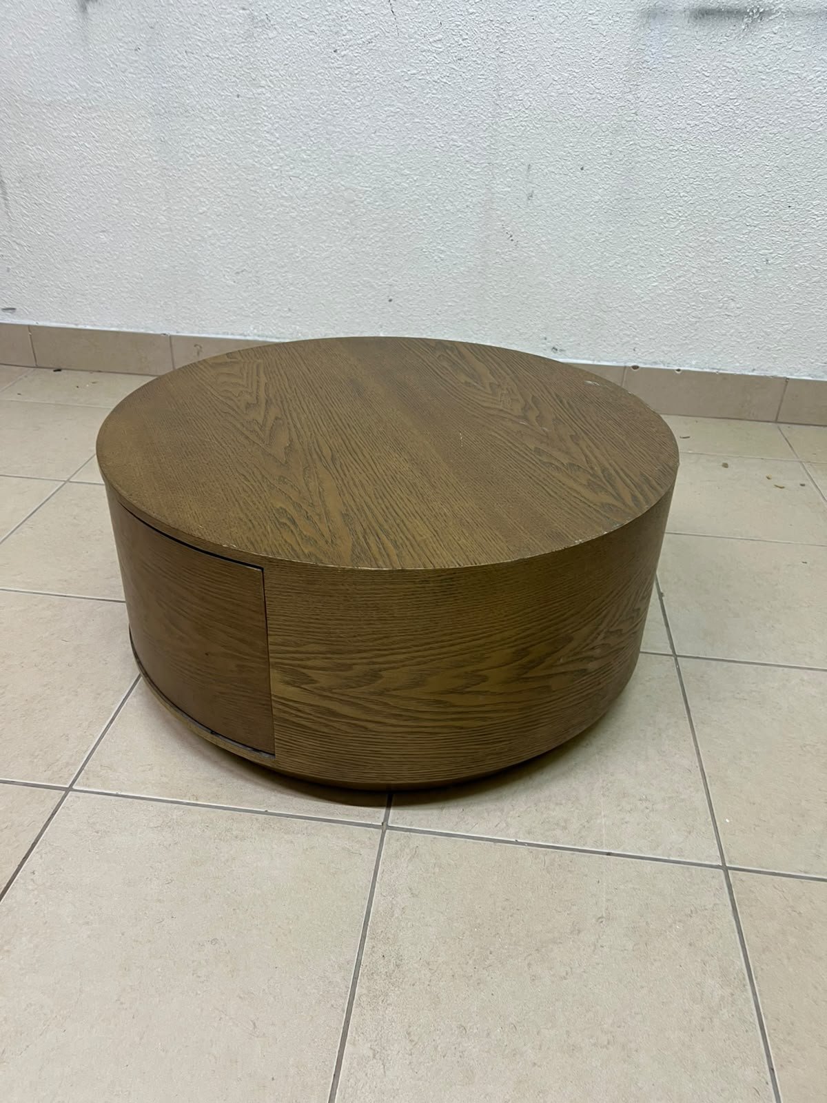 A round, dark oak-colored wooden coffee table, featuring an elegant, modern design with a curved storage drawer equipped with concealed or recessed handles. - Image 3