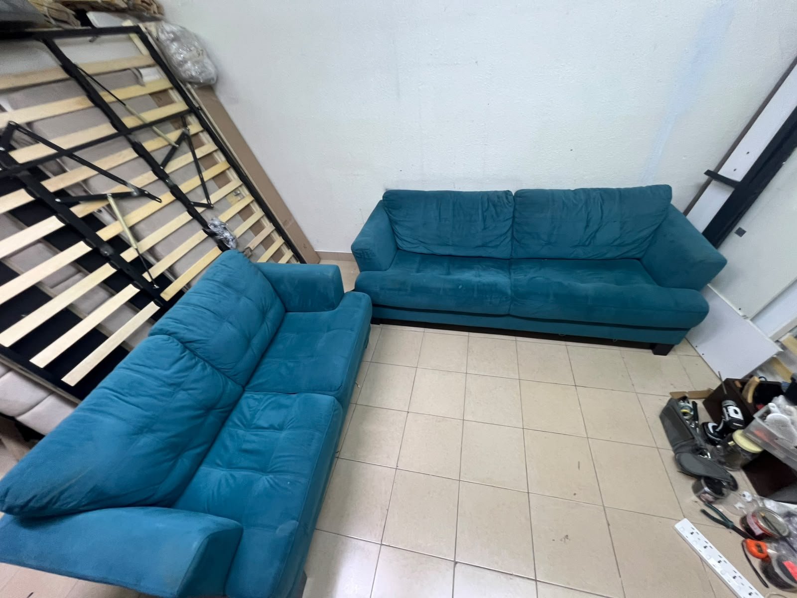 A velvet sofa set in a teal (blue-green) color, consisting of a two-seater sofa and a larger three-seater sofa.
