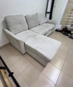 # Convertible Fabric Corner Sofa Bed with Chaise Longue and Storage – Home Box UAE Upgrade your living room with this practical and stylish convertible fabric corner sofa bed from Home Box UAE, designed to combine comfort, functionality, and modern elegance in one versatile piece of furniture. Featuring a spacious three-seater design with an extended chaise longue, this sofa provides plenty of room for relaxing, watching television, entertaining guests, or spending quality time with family. Its attractive fabric upholstery adds a warm and welcoming touch to any living space, making it an excellent choice for apartments, villas, guest rooms, and modern homes. One of the main advantages of this corner sofa is its convertible sofa-bed function, which allows you to transform the seating area into a comfortable sleeping space whenever needed. This practical feature makes it especially suitable for homes where extra sleeping arrangements are occasionally required without sacrificing valuable floor space. Whether you have overnight visitors or simply want a comfortable place to stretch out and relax, this multifunctional design offers flexibility for everyday living. The extended chaise longue provides additional legroom, allowing you to sit back comfortably, read a book, enjoy your favourite shows, or take a relaxing afternoon nap. The spacious seating arrangement makes it suitable for individuals, couples, and families looking for furniture that offers both convenience and comfort. Another useful feature is the integrated storage compartment, which provides extra room for keeping blankets, pillows, bedsheets, cushions, and other household essentials neatly organised and within easy reach. With its combination of seating, sleeping, and storage functions, this fabric corner sofa is an excellent space-saving solution for contemporary interiors. Its versatile design allows it to serve as the main sofa in a living room while also functioning as a guest bed and a convenient storage unit. The fabric finish complements a variety of interior styles, including modern, minimalist, contemporary, and casual home décor, making it easy to incorporate into different living environments. If you are searching for an affordable and functional sofa bed in Dubai, Sharjah, or Ajman, this Home Box-style convertible corner sofa is worth considering for its practical features and versatile use. It is particularly suitable for people furnishing a new apartment, upgrading their existing living room, or looking for multifunctional furniture that makes the most of available space. At Yahya Used Furniture, we offer a wide selection of second-hand furniture for customers looking for practical home furnishing solutions at affordable prices. If you are interested in buying a used corner sofa, sofa bed, chaise longue, or other living room furniture, explore our available collection to discover options that suit your space and budget. Choose a sofa that brings together comfortable seating, flexible sleeping arrangements, and useful storage in one convenient design. This convertible fabric corner sofa bed is a practical furniture choice for making your living room more comfortable, organised, and ready for everyday life. - Image 6