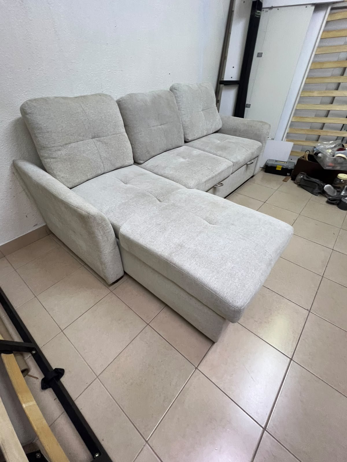 # Convertible Fabric Corner Sofa Bed with Chaise Longue and Storage – Home Box UAE Upgrade your living room with this practical and stylish convertible fabric corner sofa bed from Home Box UAE, designed to combine comfort, functionality, and modern elegance in one versatile piece of furniture. Featuring a spacious three-seater design with an extended chaise longue, this sofa provides plenty of room for relaxing, watching television, entertaining guests, or spending quality time with family. Its attractive fabric upholstery adds a warm and welcoming touch to any living space, making it an excellent choice for apartments, villas, guest rooms, and modern homes. One of the main advantages of this corner sofa is its convertible sofa-bed function, which allows you to transform the seating area into a comfortable sleeping space whenever needed. This practical feature makes it especially suitable for homes where extra sleeping arrangements are occasionally required without sacrificing valuable floor space. Whether you have overnight visitors or simply want a comfortable place to stretch out and relax, this multifunctional design offers flexibility for everyday living. The extended chaise longue provides additional legroom, allowing you to sit back comfortably, read a book, enjoy your favourite shows, or take a relaxing afternoon nap. The spacious seating arrangement makes it suitable for individuals, couples, and families looking for furniture that offers both convenience and comfort. Another useful feature is the integrated storage compartment, which provides extra room for keeping blankets, pillows, bedsheets, cushions, and other household essentials neatly organised and within easy reach. With its combination of seating, sleeping, and storage functions, this fabric corner sofa is an excellent space-saving solution for contemporary interiors. Its versatile design allows it to serve as the main sofa in a living room while also functioning as a guest bed and a convenient storage unit. The fabric finish complements a variety of interior styles, including modern, minimalist, contemporary, and casual home décor, making it easy to incorporate into different living environments. If you are searching for an affordable and functional sofa bed in Dubai, Sharjah, or Ajman, this Home Box-style convertible corner sofa is worth considering for its practical features and versatile use. It is particularly suitable for people furnishing a new apartment, upgrading their existing living room, or looking for multifunctional furniture that makes the most of available space. At Yahya Used Furniture, we offer a wide selection of second-hand furniture for customers looking for practical home furnishing solutions at affordable prices. If you are interested in buying a used corner sofa, sofa bed, chaise longue, or other living room furniture, explore our available collection to discover options that suit your space and budget. Choose a sofa that brings together comfortable seating, flexible sleeping arrangements, and useful storage in one convenient design. This convertible fabric corner sofa bed is a practical furniture choice for making your living room more comfortable, organised, and ready for everyday life. - Image 6