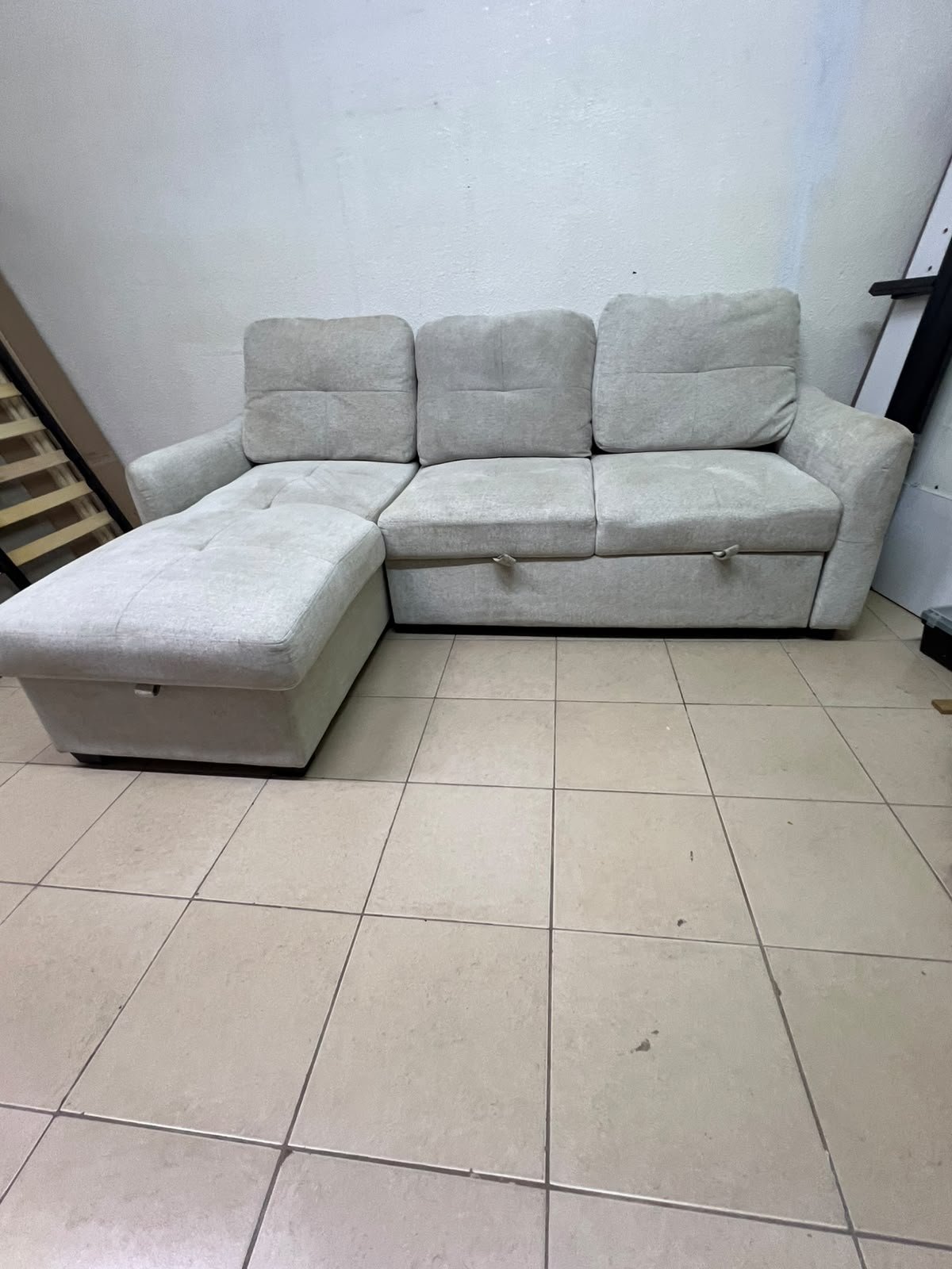 # Convertible Fabric Corner Sofa Bed with Chaise Longue and Storage – Home Box UAE Upgrade your living room with this practical and stylish convertible fabric corner sofa bed from Home Box UAE, designed to combine comfort, functionality, and modern elegance in one versatile piece of furniture. Featuring a spacious three-seater design with an extended chaise longue, this sofa provides plenty of room for relaxing, watching television, entertaining guests, or spending quality time with family. Its attractive fabric upholstery adds a warm and welcoming touch to any living space, making it an excellent choice for apartments, villas, guest rooms, and modern homes. One of the main advantages of this corner sofa is its convertible sofa-bed function, which allows you to transform the seating area into a comfortable sleeping space whenever needed. This practical feature makes it especially suitable for homes where extra sleeping arrangements are occasionally required without sacrificing valuable floor space. Whether you have overnight visitors or simply want a comfortable place to stretch out and relax, this multifunctional design offers flexibility for everyday living. The extended chaise longue provides additional legroom, allowing you to sit back comfortably, read a book, enjoy your favourite shows, or take a relaxing afternoon nap. The spacious seating arrangement makes it suitable for individuals, couples, and families looking for furniture that offers both convenience and comfort. Another useful feature is the integrated storage compartment, which provides extra room for keeping blankets, pillows, bedsheets, cushions, and other household essentials neatly organised and within easy reach. With its combination of seating, sleeping, and storage functions, this fabric corner sofa is an excellent space-saving solution for contemporary interiors. Its versatile design allows it to serve as the main sofa in a living room while also functioning as a guest bed and a convenient storage unit. The fabric finish complements a variety of interior styles, including modern, minimalist, contemporary, and casual home décor, making it easy to incorporate into different living environments. If you are searching for an affordable and functional sofa bed in Dubai, Sharjah, or Ajman, this Home Box-style convertible corner sofa is worth considering for its practical features and versatile use. It is particularly suitable for people furnishing a new apartment, upgrading their existing living room, or looking for multifunctional furniture that makes the most of available space. At Yahya Used Furniture, we offer a wide selection of second-hand furniture for customers looking for practical home furnishing solutions at affordable prices. If you are interested in buying a used corner sofa, sofa bed, chaise longue, or other living room furniture, explore our available collection to discover options that suit your space and budget. Choose a sofa that brings together comfortable seating, flexible sleeping arrangements, and useful storage in one convenient design. This convertible fabric corner sofa bed is a practical furniture choice for making your living room more comfortable, organised, and ready for everyday life. - Image 7